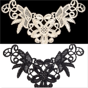 Könnte beinhalten: Zwei Spitzenborten, eine weiße und eine schwarze, mit einem floralen Muster. Beide Borten sind V-förmig und haben ein zartes, filigranes Muster.