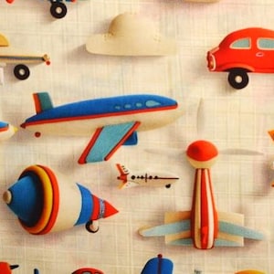 May include: A colourful fabric with a repeating pattern of toy aeroplanes, cars, and clouds. The aeroplanes are blue, red, and white, and the cars are red and white. The clouds are white.