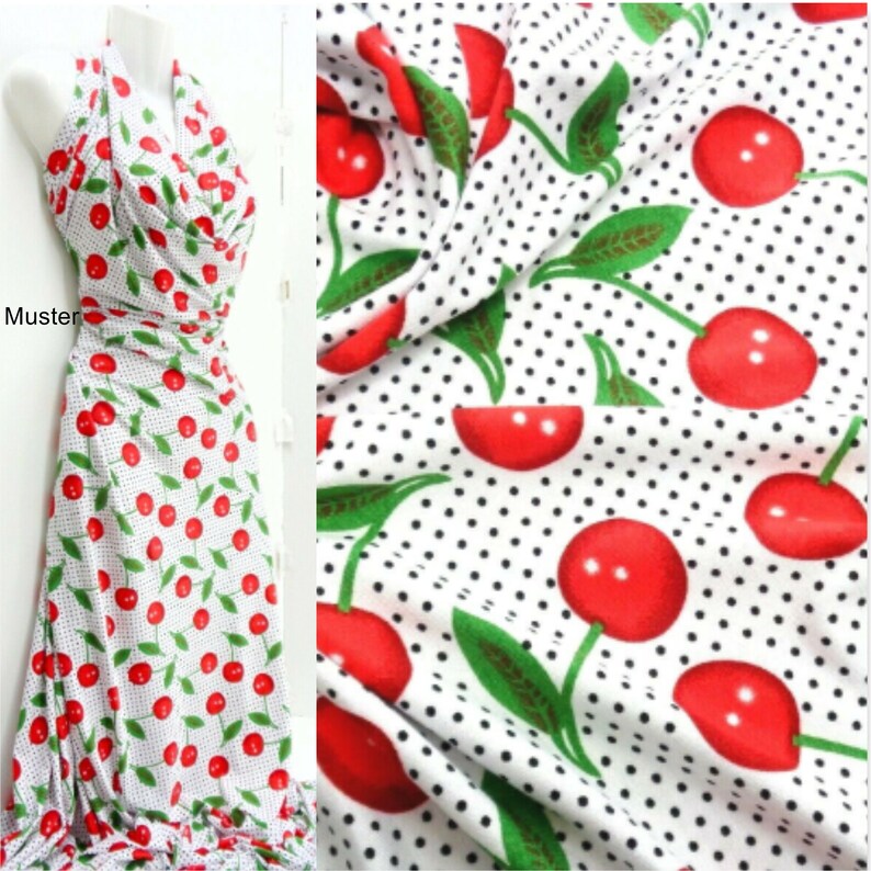 May include: White fabric with a repeating pattern of red cherries with green stems and leaves on a white background with small black polka dots.