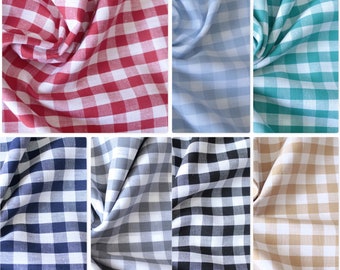 May include: A collection of fabric swatches in various colors and patterns. The swatches are all gingham, with different colored squares on a white background. The colors include red, blue, light blue, green, black, and beige.