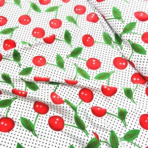 May include: White fabric with a repeating pattern of red cherries with green stems and leaves on a white background with small black polka dots.
