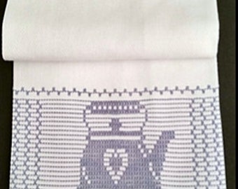 May include: White kitchen towel with a blue embroidered design of a teapot with a heart on the front. The towel has a blue border.