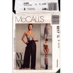 May include: McCall's sewing pattern featuring a woman in a halter top and wide-leg pants. The pattern includes options for a swimsuit and a dress. The package is white with black text and a barcode.