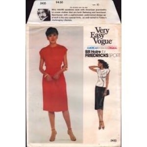 May include: A vintage sewing pattern package featuring a red dress and a black and white top and skirt. The package has the text "Very Easy Vogue" and "Bill Haire for Friedricks Sport". The model on the package is wearing the red dress.