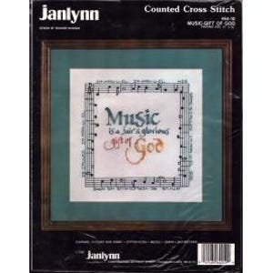 May include: A counted cross-stitch kit by Janlynn, featuring the text "Music is a fair & glorious gift of God" in a decorative frame. The design includes musical notes and is presented in a black frame with a green mat.