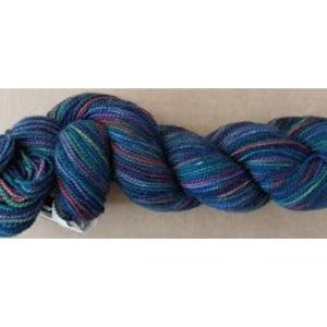 May include: A skein of hand-dyed yarn in shades of blue, teal, purple, and red. The yarn is twisted into a loose, elongated shape, showcasing the color variations. The yarn appears soft and suitable for knitting or crochet projects.