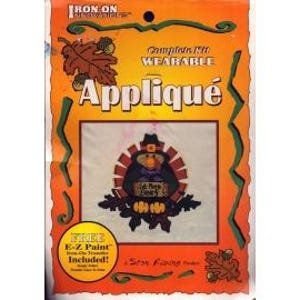 May include: Iron-on applique kit featuring a Thanksgiving turkey design. The turkey is wearing a hat and has a "Gobble 'til you wobble" banner. The kit includes free E-Z Paint.