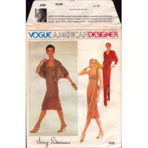 May include: A Vogue American Designer sewing pattern envelope, number 2328, featuring illustrations of three dresses. One dress is brown with a matching bolero, another is a peach-colored slip dress, and the third is a long red dress with a jacket.