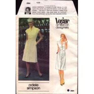 May include: A vintage Vogue American Designers sewing pattern for a dress by Adele Simpson. The pattern is for a sleeveless dress with a collar and a tie belt. The pattern is for size 10.