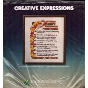 May include: A framed cross-stitch kit titled "The Kitchen Witch's Humble Rules For Things." The text is surrounded by a floral border. The kit is packaged in a clear plastic sleeve with the words "Creative Expressions" at the top.