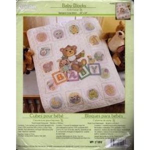 May include: A white baby quilt with embroidered blocks featuring animal and teddy bear designs. The quilt has the text "Baby Blocks" and measures 34" x 43". The quilt is packaged in a clear plastic bag.
