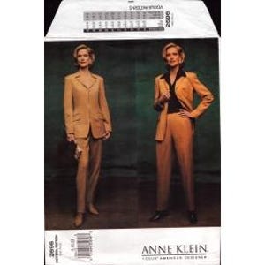 May include: Vogue sewing pattern 2696 featuring a two-piece suit designed by Anne Klein. The pattern includes a tailored jacket and pants. The image shows a woman wearing the suit in a light brown color. The pattern is for an adult.