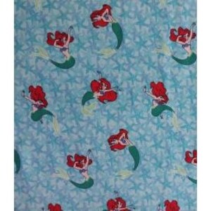 May include: Light blue fabric with a repeating pattern of red-haired mermaids with green tails and starfish. The mermaids are in various poses, with their arms raised. The starfish are light blue.