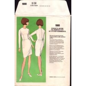 May include: A vintage sewing pattern envelope labeled 1000, Vogue's Guide to Perfect Fit of Fitted Garments. The front features a green rectangular panel with two illustrations of a figure in a long-sleeved white dress, shown from front and back views.