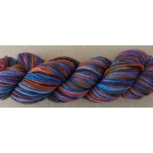 May include: A skein of hand-dyed yarn with a blend of colors including blue, orange, pink, and brown. The yarn appears to be a medium weight, suitable for knitting or crocheting projects. The colors are variegated, creating a textured appearance.