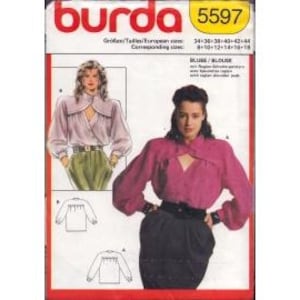 May include: A vintage Burda sewing pattern, model 5597, featuring a blouse design. The pattern includes illustrations of the blouse and a photo of a woman wearing the blouse. The pattern's color scheme is red, white, and yellow.