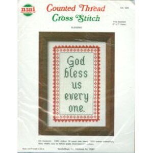 May include: A packaged cross-stitch kit featuring a framed design with the text "God bless us every one." The kit includes a brown wooden frame, red and green accents, and the brand name "nmi" in the upper left corner. The finished size is 8" x 10".