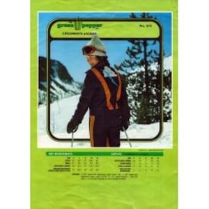 May include: Vintage children's ski jacket from Green Pepper, featuring a skier in a navy blue and orange jumpsuit with a white and gray hat and goggles. The jacket has orange suspenders and is set against a snowy mountain backdrop.