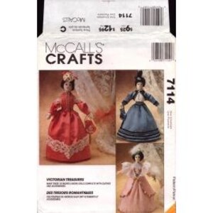 May include: McCall's Crafts sewing pattern number 7114 for Victorian doll clothes. The pattern includes three different outfits: a red dress with lace trim, a blue dress with a striped skirt, and a pink dress with a lace trim. The pattern is for dolls with a 12-inch waist.