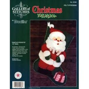 May include: A Christmas felt stocking kit featuring a Santa Claus design. The kit includes felt pieces, embroidery floss, and other supplies. The finished stocking measures 18 inches (45.7 cm) tall. The packaging includes the text "Gallery of Stitches" and "Christmas".