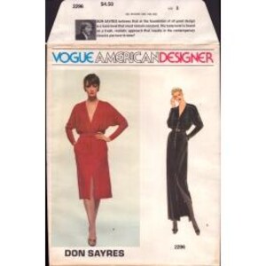May include: Vogue American Designer sewing pattern for a dress by Don Sayres. The pattern shows two versions of the dress, one in red and one in black. The dress has a V-neckline, long sleeves, and a fitted silhouette.