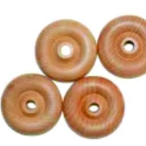 May include: Four wooden wheels with a hole in the center. The wheels are a light brown color with a wood grain pattern.