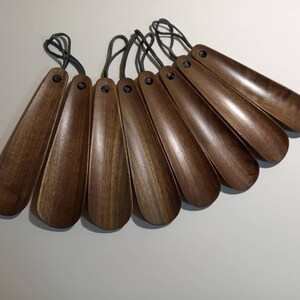 8 shoe horns. Walnut. Elm.