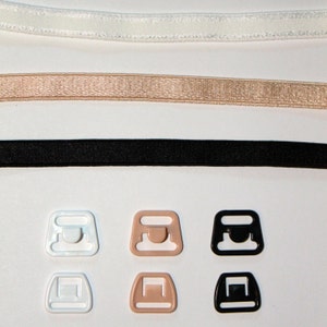 May include: Three sets of bra strap adjusters in white, beige, and black. Each set includes a hook and eye closure and a slider.