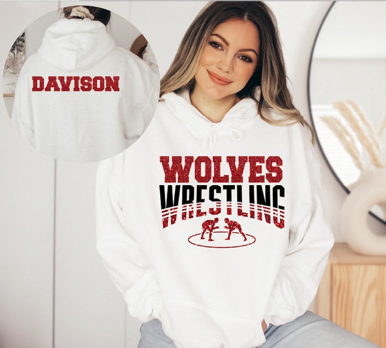 May include: White hoodie with red glitter text that says "WOLVES WRESTLING" and a graphic of two wrestlers in a circle. The back of the hoodie has red glitter text that says "DAVISON".