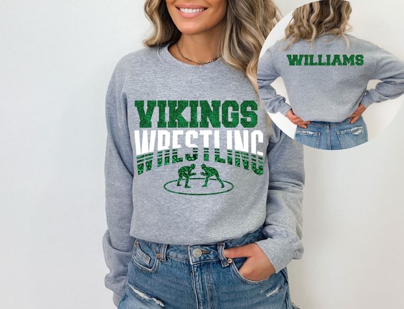 May include: Gray sweatshirt with green glitter text that says "Vikings Wrestling" and a graphic of two wrestlers. The back of the sweatshirt has the text "Williams" in green glitter.