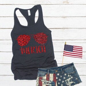 May include: A dark grey tank top with a red glitter design of sunglasses and the word "Merica".