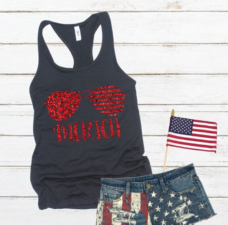 May include: A dark grey tank top with a red glitter design of sunglasses and the word "Merica".
