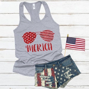 May include: A grey tank top with a red glitter design of sunglasses with an American flag pattern. The text 'MERICA' is printed below the sunglasses.