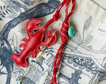 Personalizable lobster bag charm.