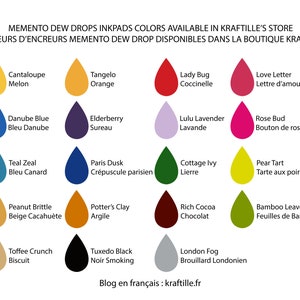 May include: A chart of 16 different ink pad colors from the Memento Dew Drop Inkpad line. The colors are displayed in a grid of four rows and four columns. Each color is represented by a teardrop-shaped ink pad with the color name and French translation below it. The colors include Cantaloupe Melon, Tangelo Orange, Lady Bug Coccinelle, Love Letter Lettre d'amour, Danube Blue Bleu Danube, Elderberry Sureau, Lulu Lavender Lavande, Rose Bud Bouton de rose, Teal Zeal Bleu Canard, Paris Dusk Cr&eacute;puscule parisien, Cottage Ivy Lierre, Pear Tart Tarte aux poires, Peanut Brittle Beige Cacahu&egrave;te, Potter's Clay Argile, Toffee Crunch Biscuit, Tuxedo Black Noir Smoking, Rich Cocoa Chocolat, Bamboo Leaves Feuilles de Bambou, and London Fog Brouillard Londonien. The chart is titled "Memento Dew Drops Inkpads Colors Available in Kraftille's Store" and "Couleurs d'Encreurs Memento Dew Drop Disponibles Dans La Boutique Kraftille". The text "Blog en fran&ccedil;ais: kraftille.fr" is at the bottom of the chart.