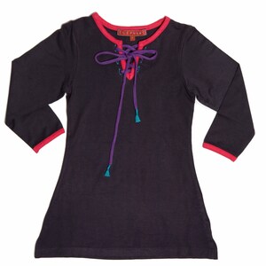 May include: A dark grey long-sleeved top with a lace-up neckline. The neckline and cuffs are trimmed in red, with purple and teal accents on the lace-up detail. The brand name "ELEPHANT" is visible on a small tag near the neckline.