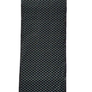 May include: Black and gray textured rectangular rug with a repeating pattern of small circles.