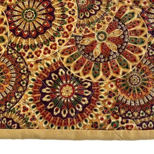 May include: A quilted fabric with a repeating pattern of colourful, intricate mandala designs. The fabric has a tan border.