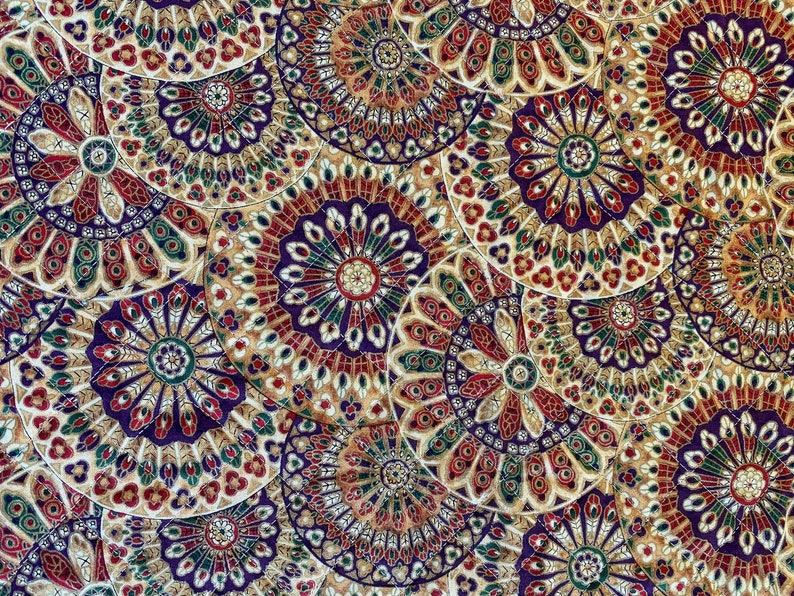 May include: A fabric with a repeating pattern of colourful, intricate mandala designs. The fabric features a gold background with purple, red, and green accents.