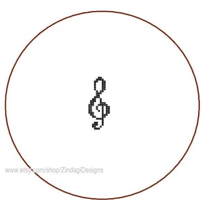 May include: A brown circle with a black treble clef symbol in the center. The text "www.etsy.com/shop/ZindagiDesigns" is at the bottom of the circle.