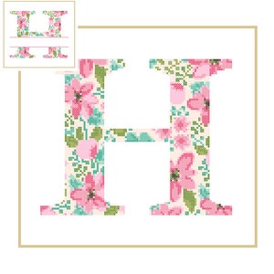 May include: A floral patterned letter H in pink, green, and white. The letter is surrounded by a gold frame.
