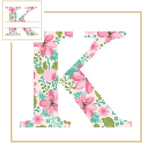 May include: A floral patterned letter K in pink, green, and white. The letter is outlined in gold.