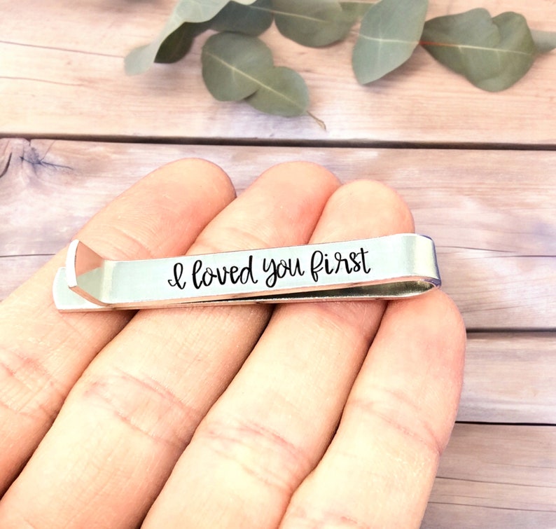 May include: Silver tie clip with the inscription "I loved you first" engraved on it.