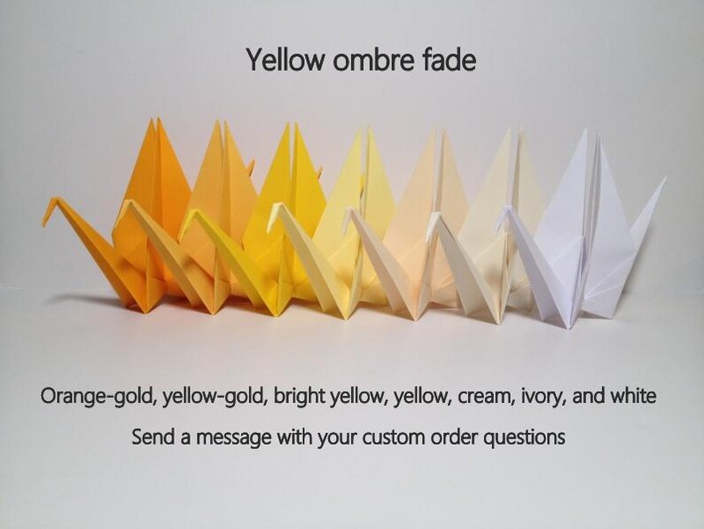 May include: A row of origami cranes in a yellow ombre fade, ranging from orange-gold to white. The text "Yellow ombre fade" is above the cranes. The text below reads "Orange-gold, yellow-gold, bright yellow, yellow, cream, ivory, and white".