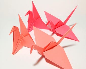 Group Of Red Origami Cranes Flying Away by Paper Boat Creative