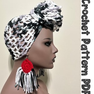 May include: A crochet head wrap in black, white and grey with a loose, open weave. The wrap is tied in a knot on top of the head. The wrap is being modelled on a mannequin with red and white tassel earrings.