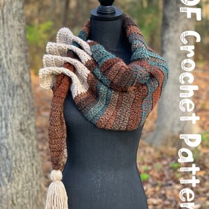 May include: A crocheted scarf with a long tassel, featuring brown, beige, and teal stripes. The scarf is draped over a black mannequin. The text "PDF Crochet Pattern" is written in white on a white background in the upper right corner of the image.