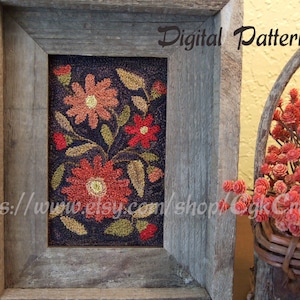 May include: A framed digital pattern for rug hooking featuring a floral design with red, orange, and yellow flowers on a dark blue background. The frame is made of weathered wood.
