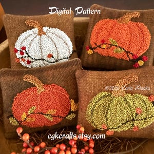 May include: Four brown throw pillows with embroidered pumpkin designs. One pillow features a white pumpkin, two have orange pumpkins, and one has a yellow-green pumpkin. The text "Digital Pattern" and "cgkcrafts etsy.com" are visible.