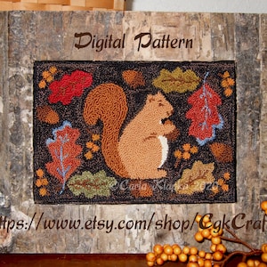 May include: Digital pattern for a needlepoint rug featuring a brown squirrel sitting amongst colorful autumn leaves on a dark brown background. The pattern is titled "Digital Pattern" and includes the website address "https://www.etsy.com/shop/CgkCrafts".